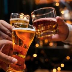 Hands holding glasses and raising a toast